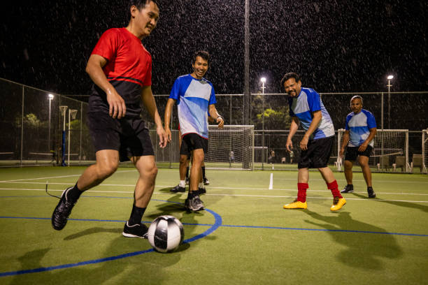 istock Soccer Players in Action on a Rainy Night 2200056683