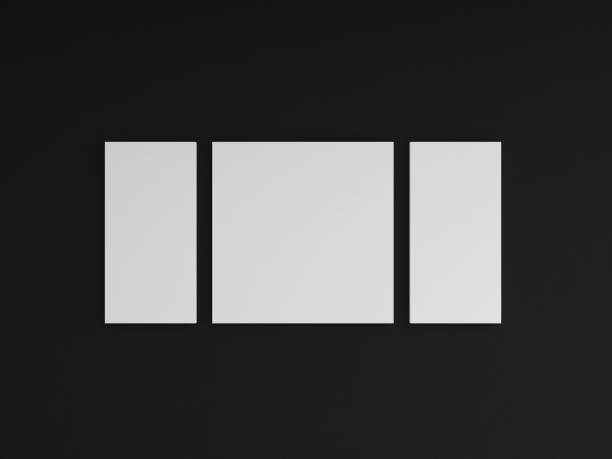 istock Mockup of two vertical and one square blank frames on a black wall 2200056692