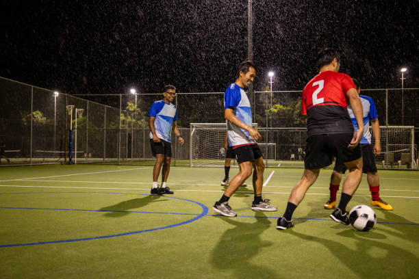 istock Soccer Players in Action on a Rainy Night 2200056723