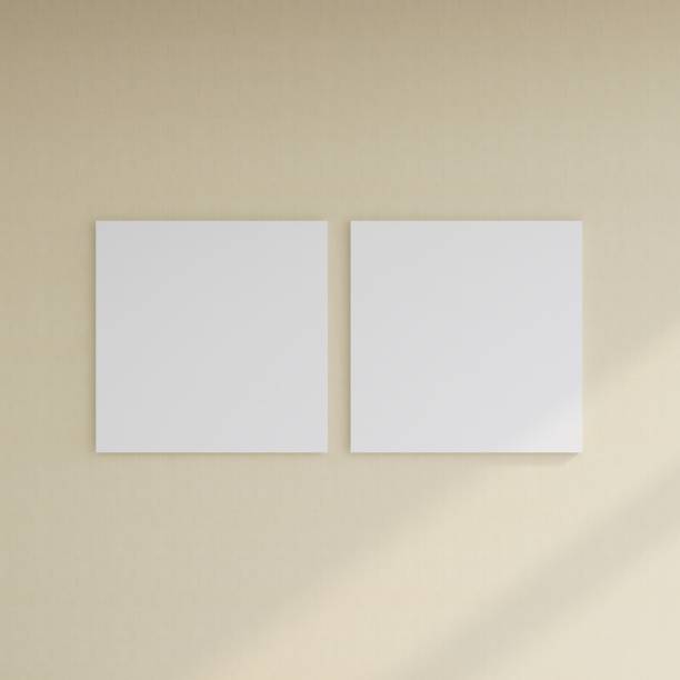 istock Mockup of two blank square frames on a pastel wall 2200056736