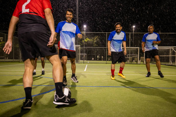 istock Soccer Players in Action on a Rainy Night 2200056764