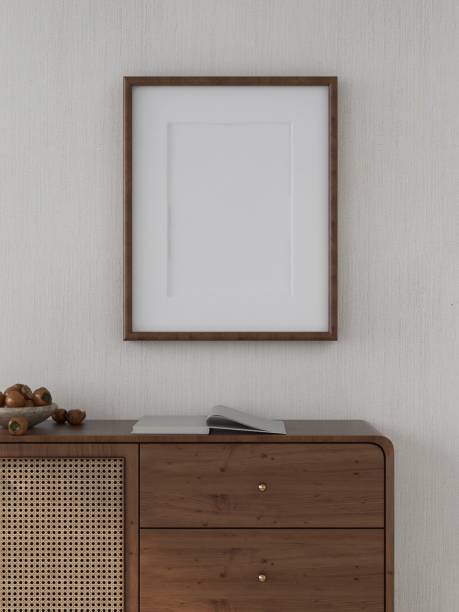 istock Blank vertical frame mockup on white wall with sideboard in decoration 2200056783