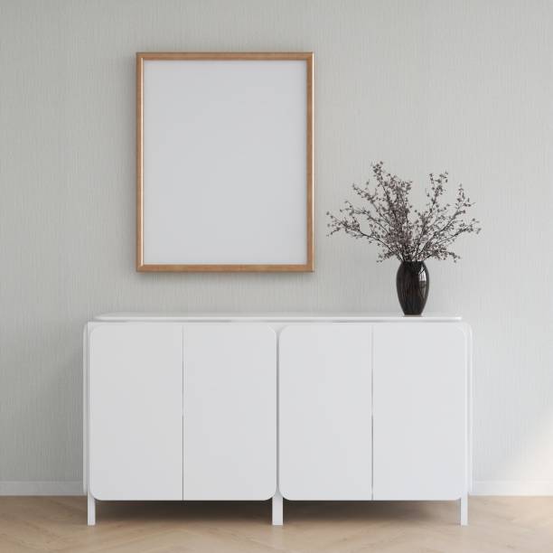 istock Blank vertical frame mockup on a wall with white sideboard in decoration 2200056829