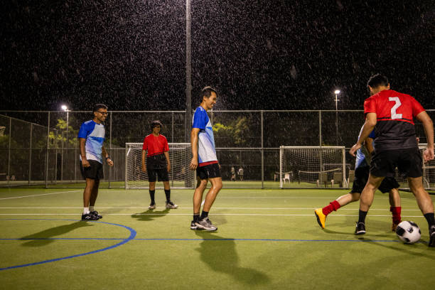 istock Rainy Night Soccer Game Featuring Diverse Players 2200056906