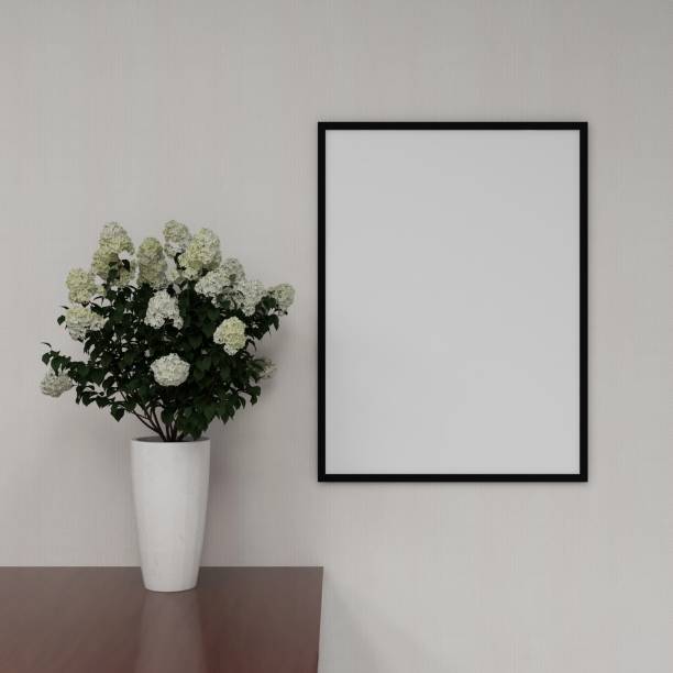 Vertical frame mockup on a white wall and interior decoration with plant on a table