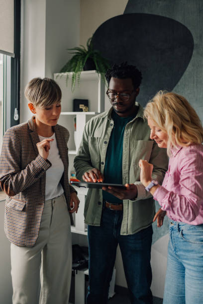 istock Business people collaborating on digital tablet in modern office 2200058646