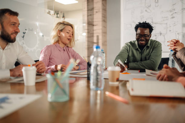 istock Diverse business team collaborating on project in modern office meeting 2200058674