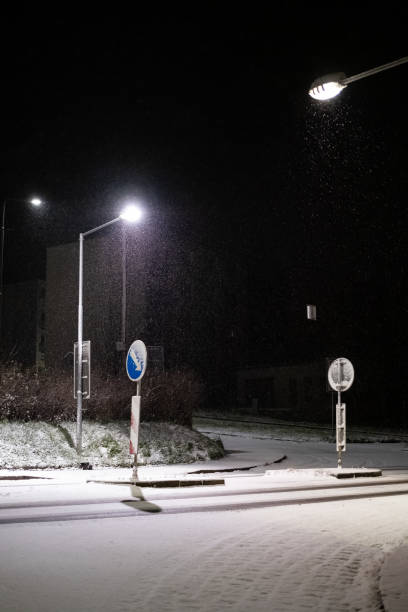 istock Snowy Night Intersection Illuminated by Streetlights 2200060789