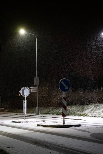 istock Snowy Night Intersection Illuminated by Streetlights 2200060790