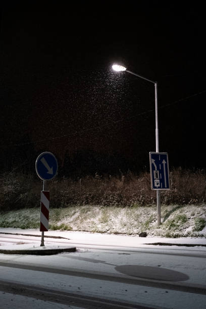 istock Snowy Night Intersection Illuminated by Streetlights 2200060793