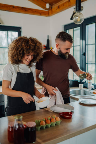 istock Happy couple preparing breakfast together in modern kitchen 2200061743