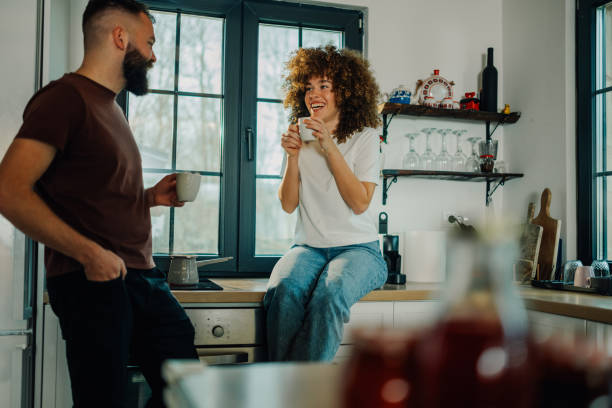 istock Happy couple enjoying morning coffee in modern kitchen 2200061774