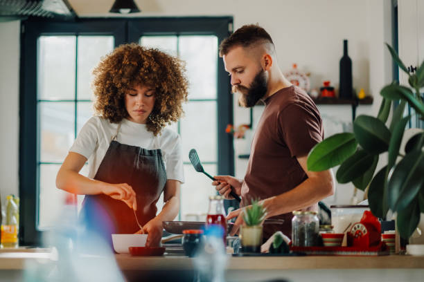 istock Couple cooking together in modern kitchen at home 2200061825