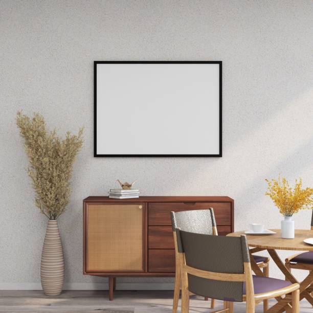 istock Horizontal frame mockup on a white wall, sideboard, table with chairs, ornamental plants and table decorations 2200063000