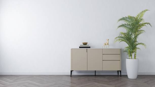 istock White wall mockup with sideboard, table decorations and palm tree in a vase, horizontal image orientation 2200063034