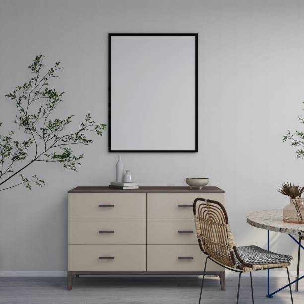 istock Mockup of vertical frame on white wall, sideboard with table decorations, dining chairs and ornamental plant 2200063095