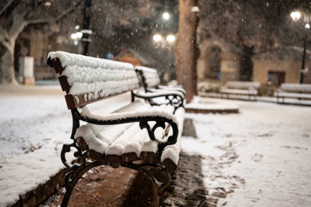 istock a bench in the park covered with snow 2200064048