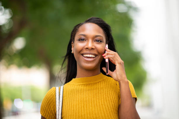 istock Happy woman talking on mobile phone 2200065273