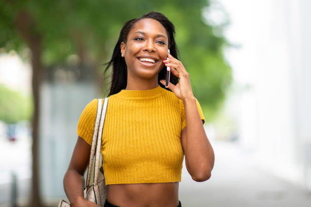 istock Happy woman talking on smart phone 2200065289