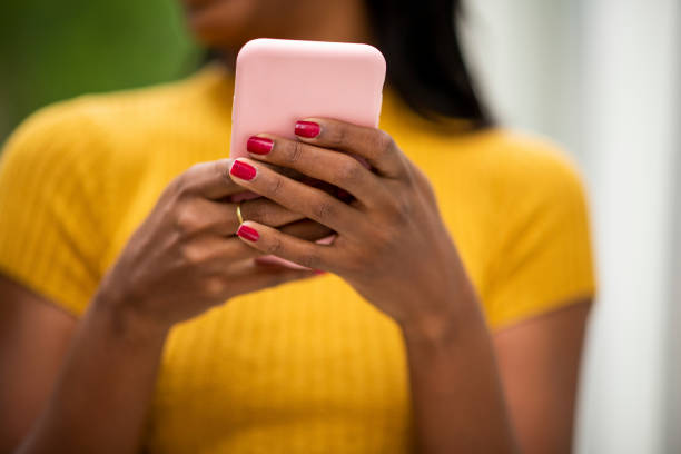 istock Black woman using mobile phone outdoors 2200065299