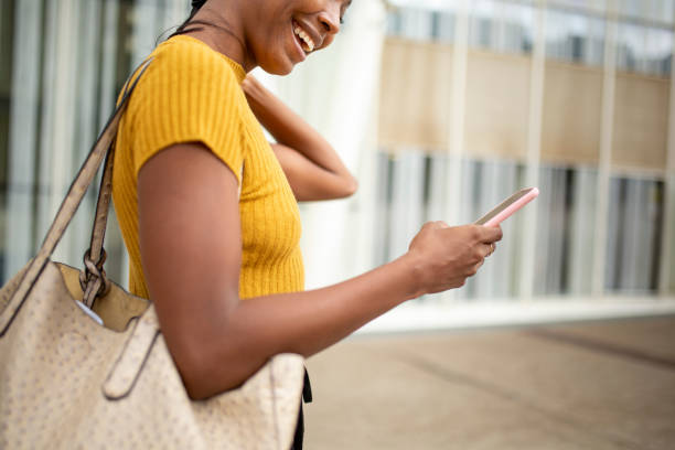 istock Profile of black woman text messaging using mobile phone 2200065340
