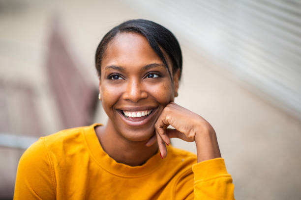 istock Cheerful black woman with hand on cheek 2200065565