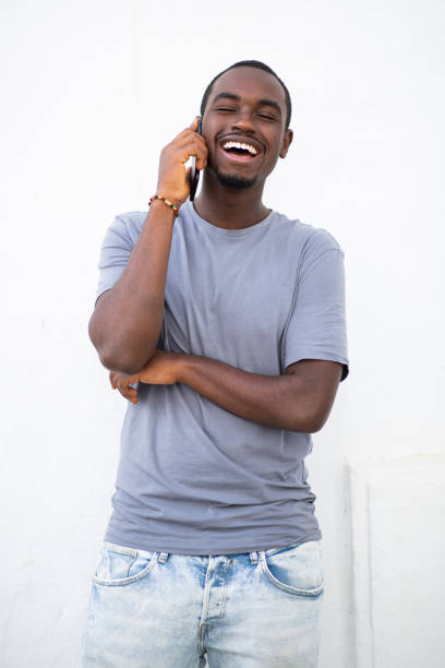istock Handsome young african man talking on mobile phone 2200065648
