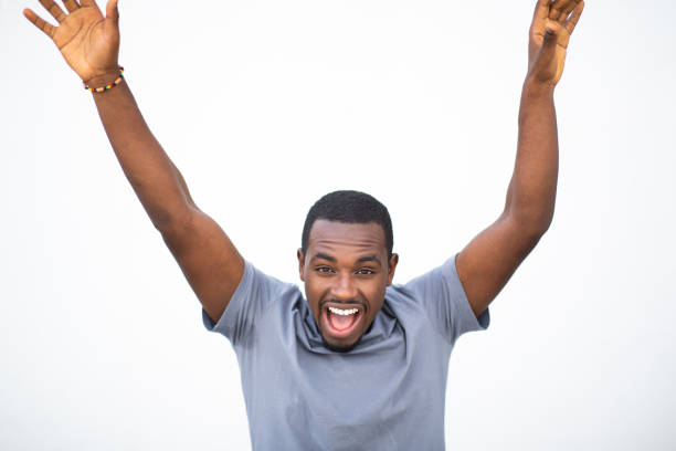 istock Excited young black man laughing with hands raised 2200065679