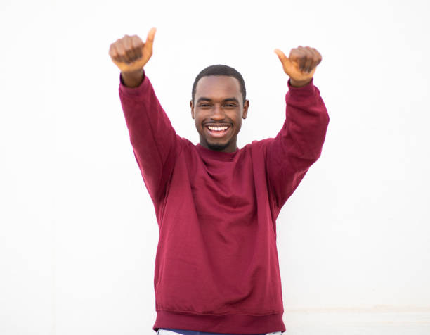 istock Happy young black guy showing thumbs up with both hands 2200065737