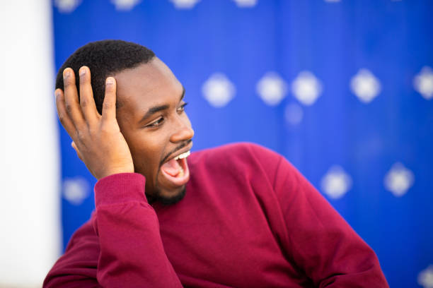 istock Excited young african guy looking away and smiling 2200065774