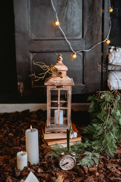 istock Decorative lantern with candles and greenery in cozy indoor setting 2200065870