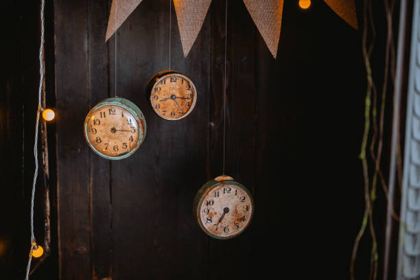 istock Unique vintage clocks hang on rustic wooden wall with warm lighting 2200065882
