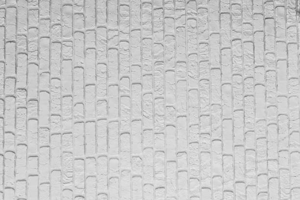 Textured white brick wall with a modern design and subtle shadows