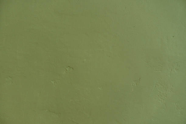 Textured green wall shows subtle markings hinting at previous decoration or wear.
