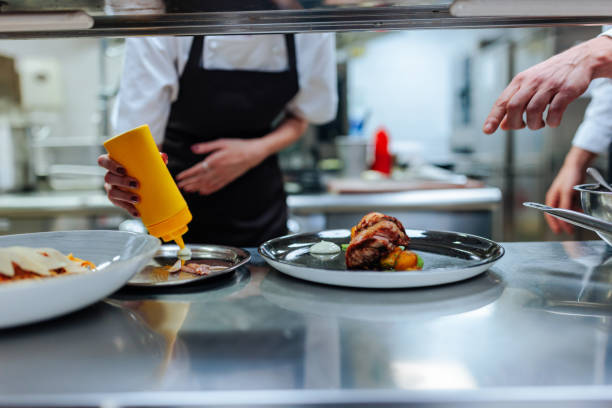 istock Chefs preparing gourmet dishes in a professional kitchen 2200065945