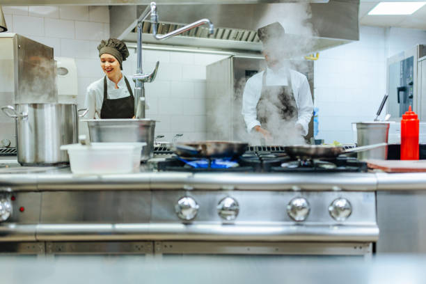 istock Chefs preparing food in a commercial kitchen 2200065970