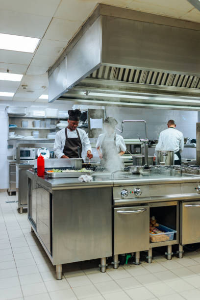 istock Chefs preparing food in a professional kitchen 2200065992