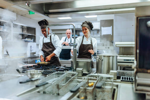 istock Chefs cooking in a busy restaurant kitchen 2200065995
