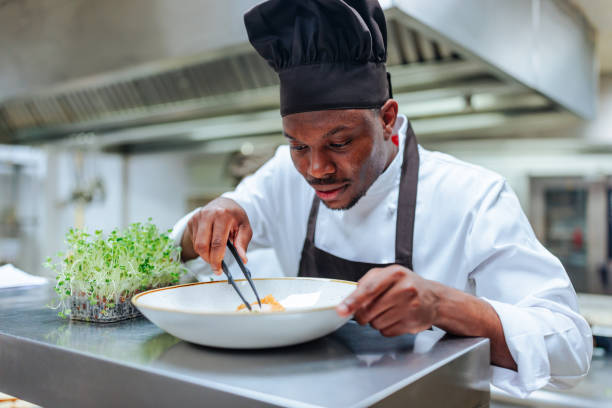 istock Chef plating food in a restaurant kitchen 2200066006
