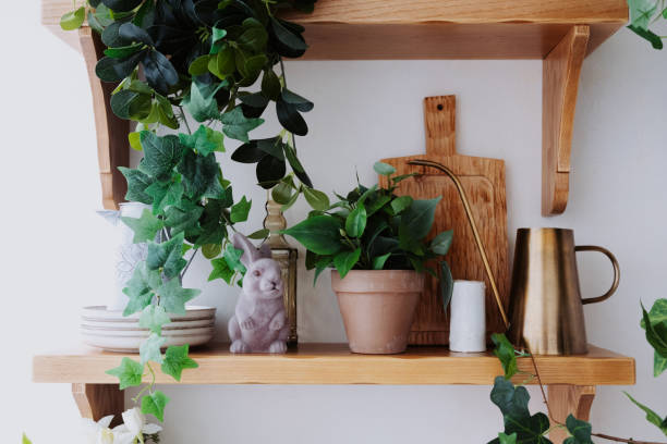 istock Decorative wooden shelf featuring plants, ceramics, and a rabbit figurine 2200066079