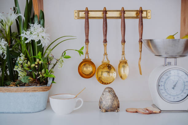istock Kitchen decor with golden utensils, scales, and decorative plants displayed 2200066109