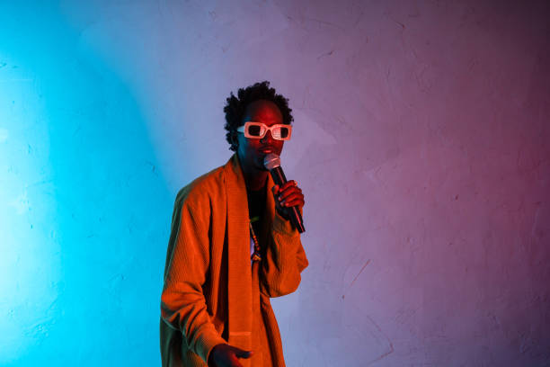 istock Male African man singing into a microphone 2200066959