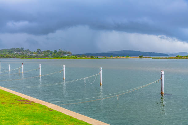 Mallacoota Inlet under a drizzly grey sky in Gippsland, Victoria, Australia.
