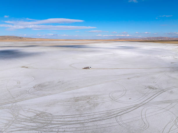 Aerial view of abandoned towing midibus stuck in the mud at Salt Lake in Konya Turkey. Taken by drone.