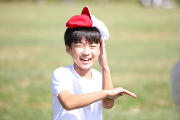 istock A boy playing with a red and white hat on his head 2200077922
