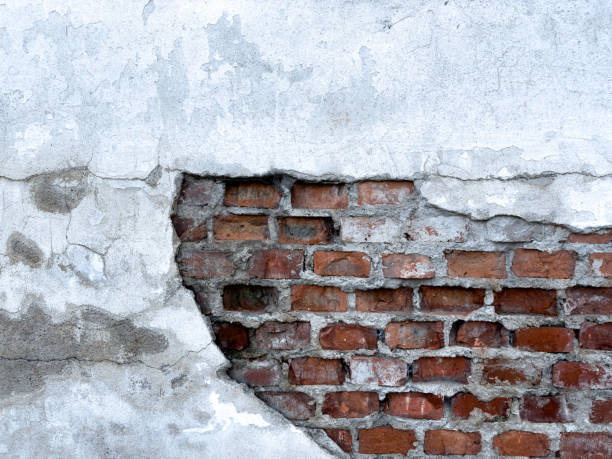 istock Exposed Brick Wall Showcasing Weathered Texture and Peeling Plaster in an Urban Setting 2200080686