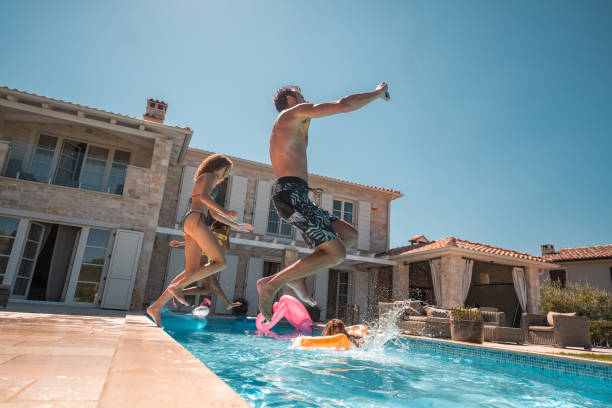 istock Jumping into the Pool with Family 2200082268