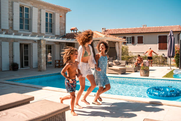 istock Poolside Fun with Young Mixed-Race Boy and Sisters 2200082291
