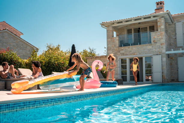 istock Young Mixed Race Siblings Run and Play by the Pool 2200082328
