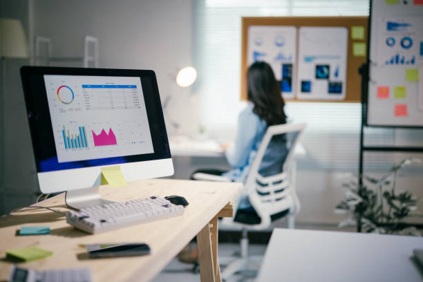istock Professional female executive reviewing financial data on computer, sticky notes scattered, smartphone resting on sleek workspace 2200085499